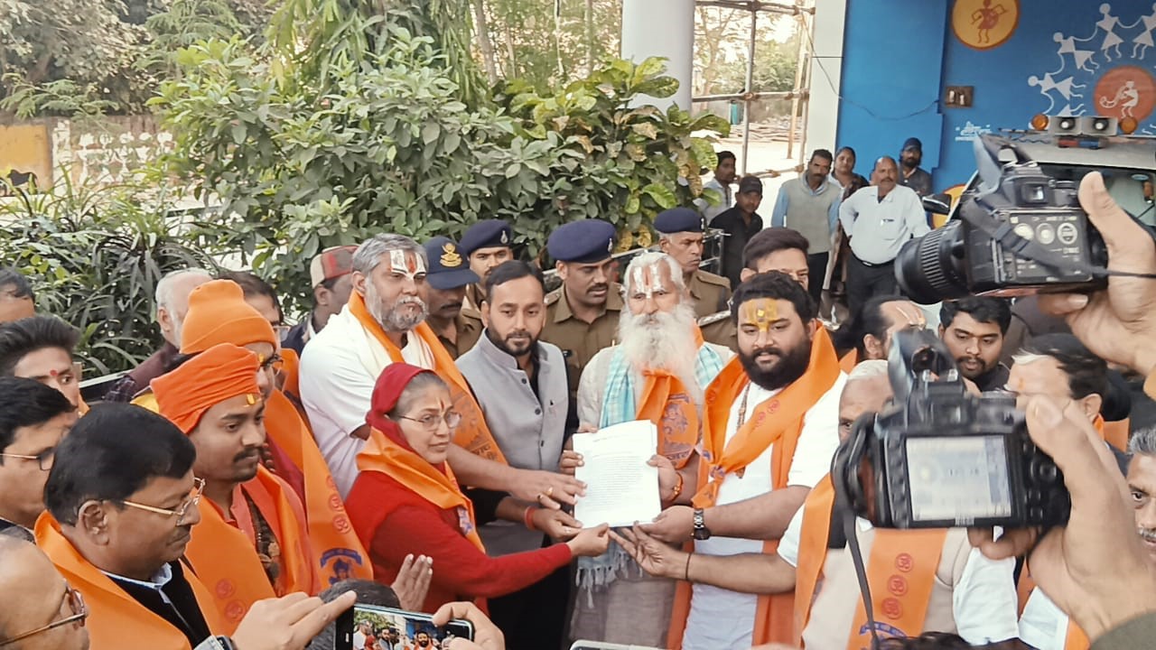 A rosary in one hand, a spear in the other